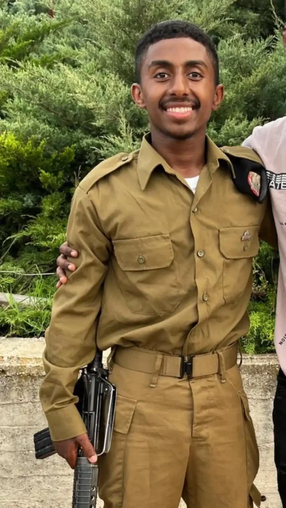 החייל קנאו קאסה הי"ד עומד במדים ואוחז בנשקו המופנה כלפי מטה.